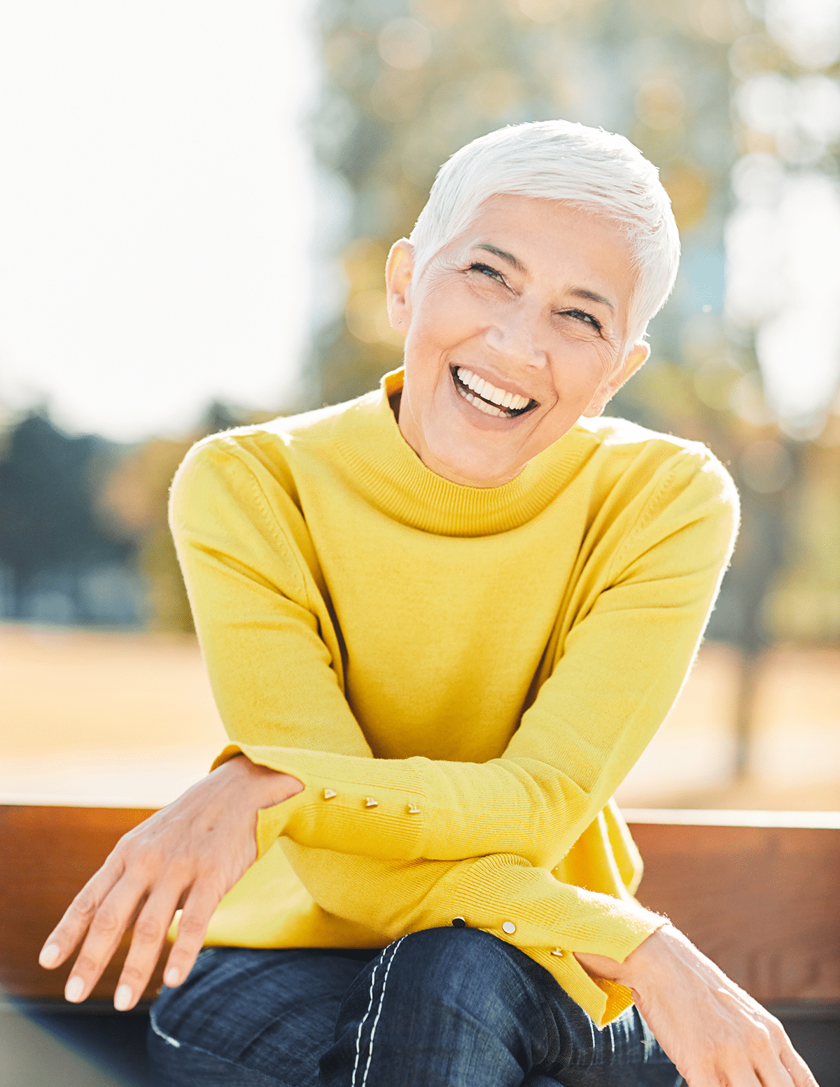 Senior woman smiling at Aura Dental Clinic, showcasing her healthy teeth and positive experience at the dental office.