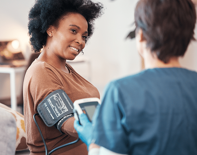 Woman at Aura Dental Clinic having her blood pressure checked by a healthcare professional.