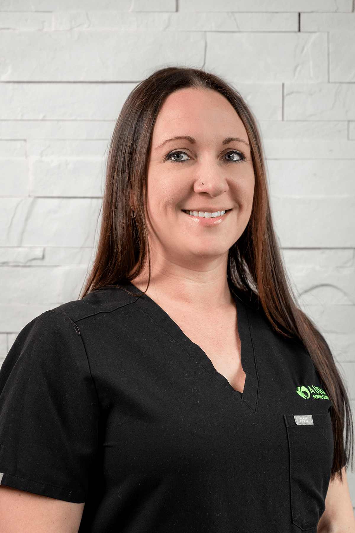 A woman wearing a black shirt and green shirt stands in front of Aura Dental Clinic, labeled 'Annette'.