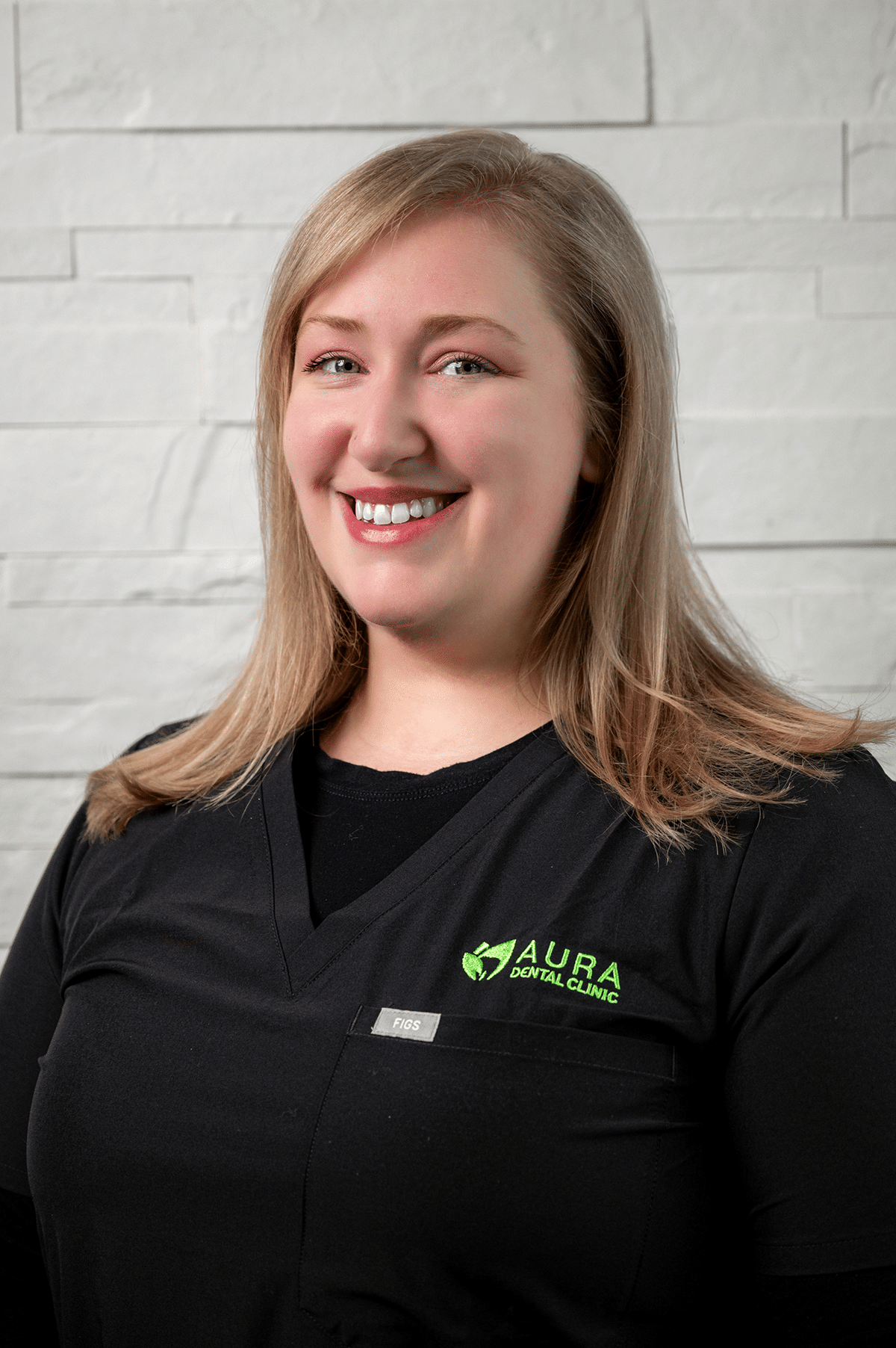 A woman wearing a black shirt and green shirt stands in front of Aura Dental Clinic, labeled 'Jade'.