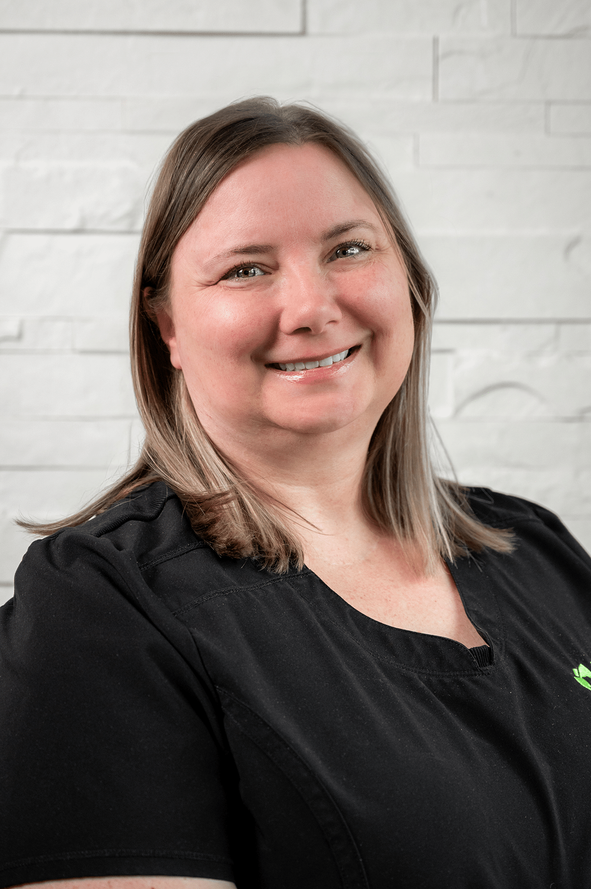 A woman wearing a black shirt and green shirt stands in front of Aura Dental Clinic, labeled 'Robyn'.